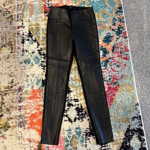 Black faux leather leggings with faux front pockets